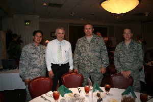 Maj. Anthony Gamboa, USAF (l), commander, 34th Combat Communications Squadron; Wil Edgerton, chief counsel (2nd from r), 38th Engineering Installation Group/JA; Col. Thomas Byrge, USAF (2nd from r), commander, 3rd Combat Communications Group; and Capt. Shannon Cummins, USAF, flight commander, Base Level Systems, 33rd Combat Communications Squadron, look forward to the featured speaker at the May luncheon.